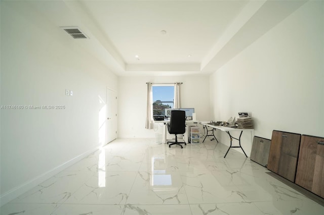 office space featuring a tray ceiling