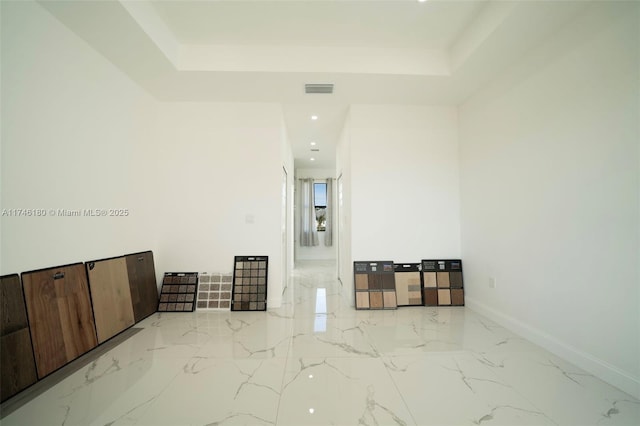 unfurnished room featuring a raised ceiling