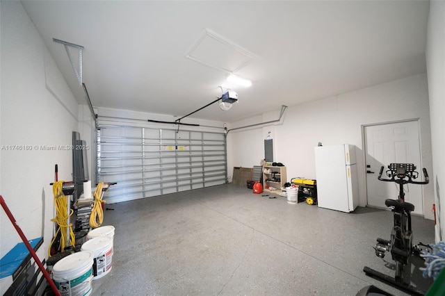 garage with white refrigerator, a garage door opener, and electric panel