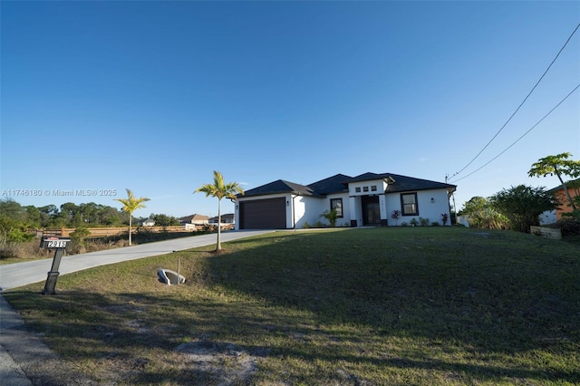 view of front of house featuring a garage and a front lawn