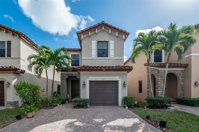 mediterranean / spanish house with a garage