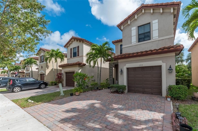 mediterranean / spanish house with a garage