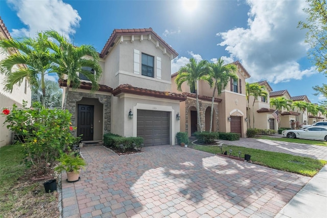 mediterranean / spanish home with a garage