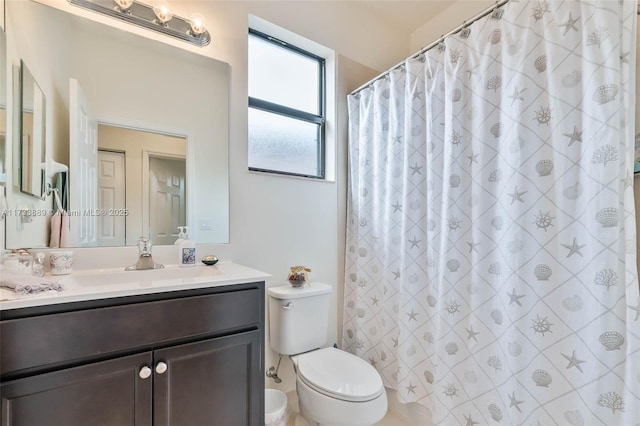 bathroom featuring vanity, toilet, and a shower with shower curtain