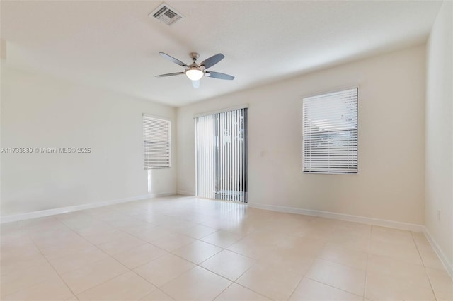 empty room with light tile patterned floors and ceiling fan