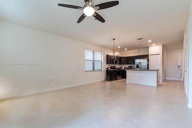 kitchen featuring appliances with stainless steel finishes, ceiling fan with notable chandelier, and a kitchen island