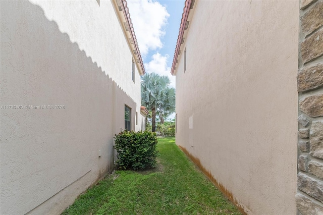 view of property exterior featuring a lawn