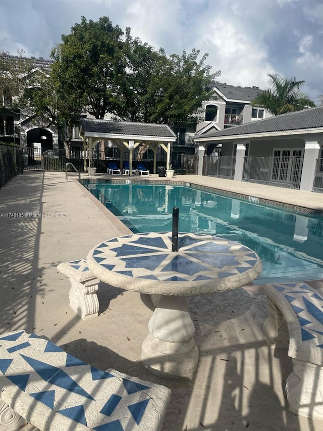 view of swimming pool featuring a patio and a gazebo