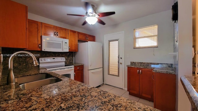 kitchen featuring sink, white appliances, light tile patterned floors, ceiling fan, and decorative backsplash