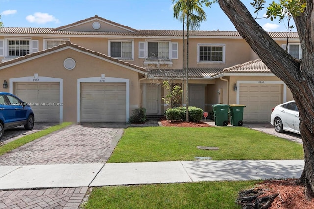 8988 Chambers St Unit 8988, Tamarac, FL 33321 - view of property featuring stucco siding, a tile roof, decorative driveway, a front yard, and a garage