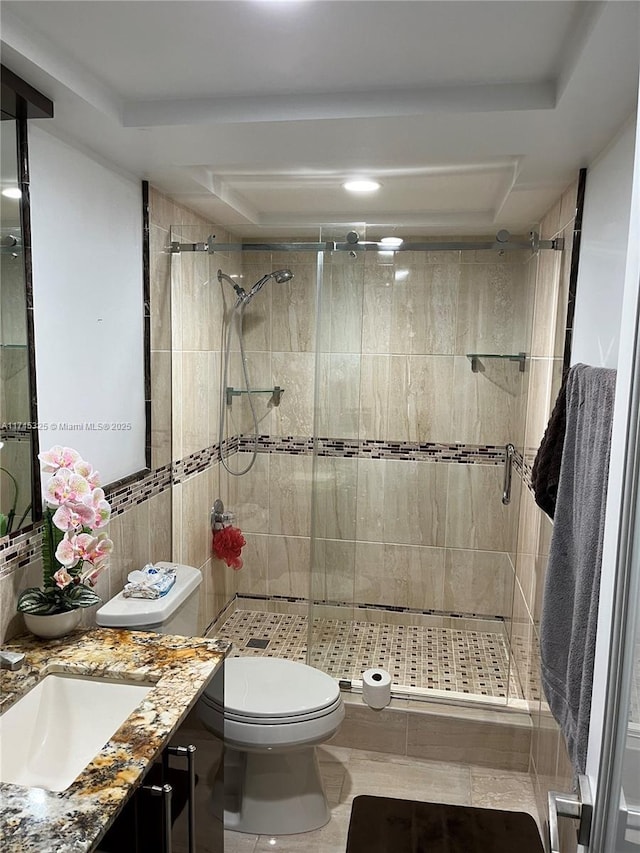 bathroom featuring vanity, toilet, and walk in shower