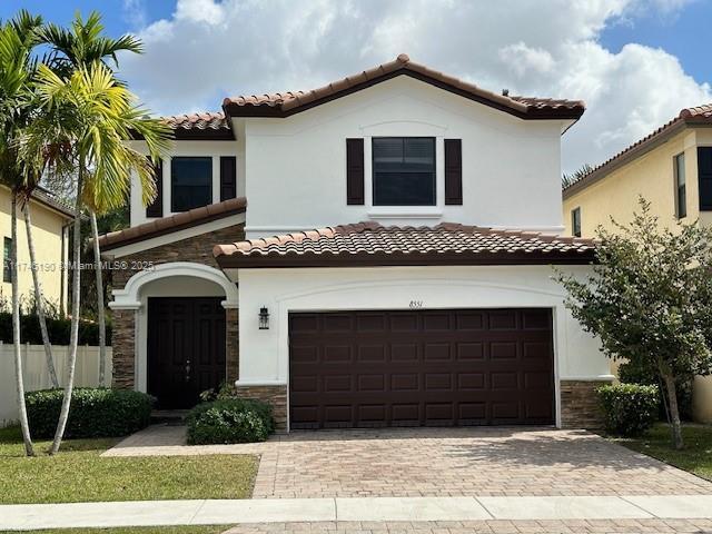 mediterranean / spanish house with a garage