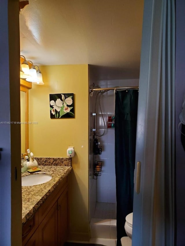 bathroom featuring vanity, toilet, and a shower with shower curtain