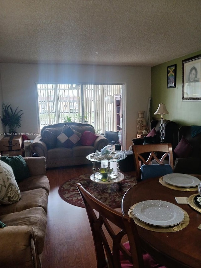 living room with hardwood / wood-style flooring and a textured ceiling