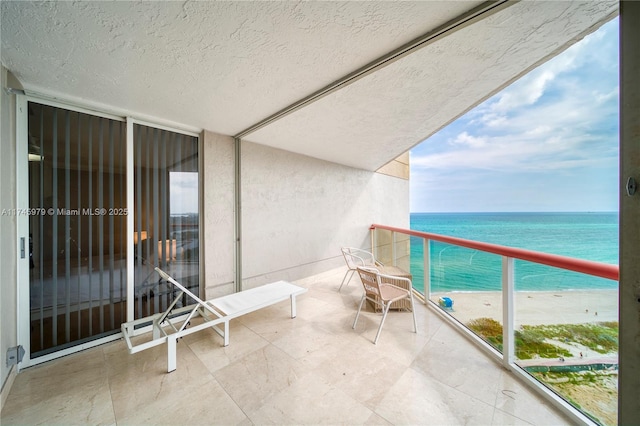 balcony with a beach view and a water view