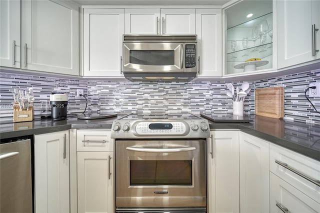 kitchen with white cabinetry, appliances with stainless steel finishes, and tasteful backsplash