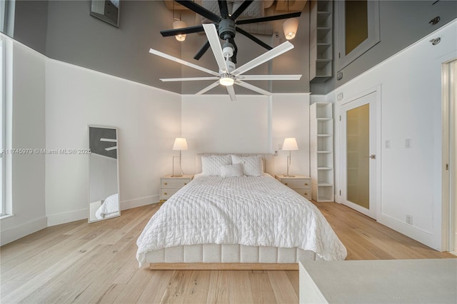 bedroom with wood-type flooring and a high ceiling