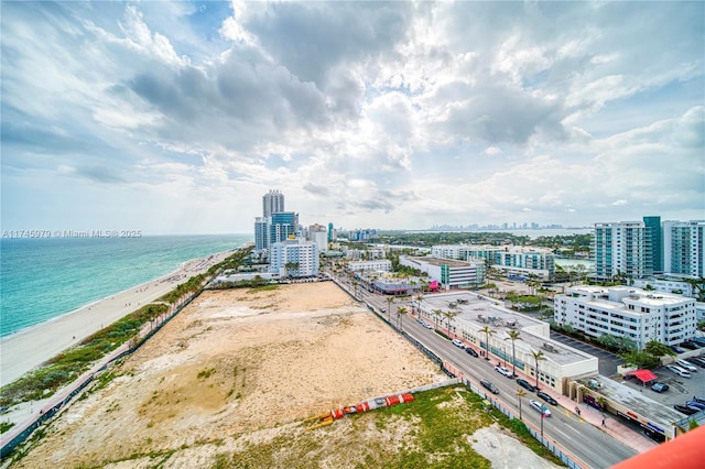 aerial view featuring a water view and a beach view