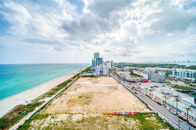 birds eye view of property featuring a view of the beach and a water view