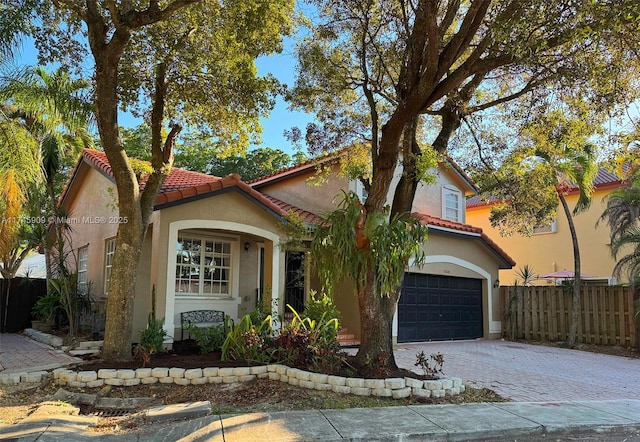 mediterranean / spanish home with a garage