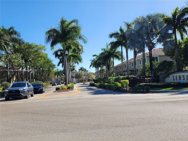 view of road with curbs, sidewalks, and street lights