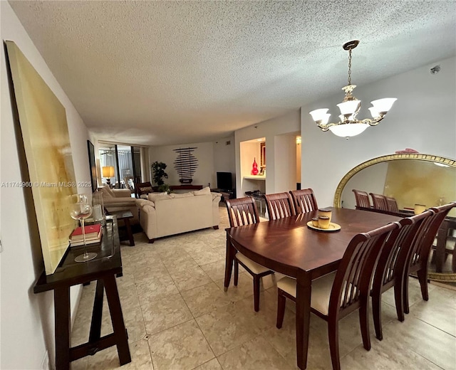 dining area with a notable chandelier, light tile patterned floors, and a textured ceiling