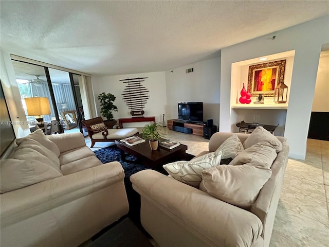 living room with floor to ceiling windows and a textured ceiling