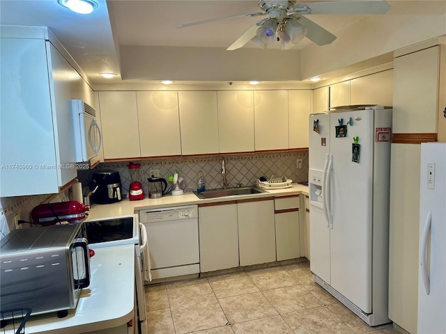 kitchen featuring sink, white appliances, ceiling fan, backsplash, and light tile patterned flooring