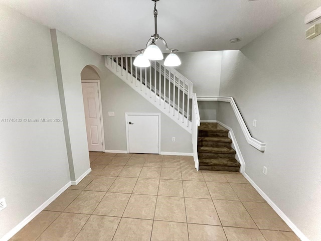 stairway with tile patterned floors