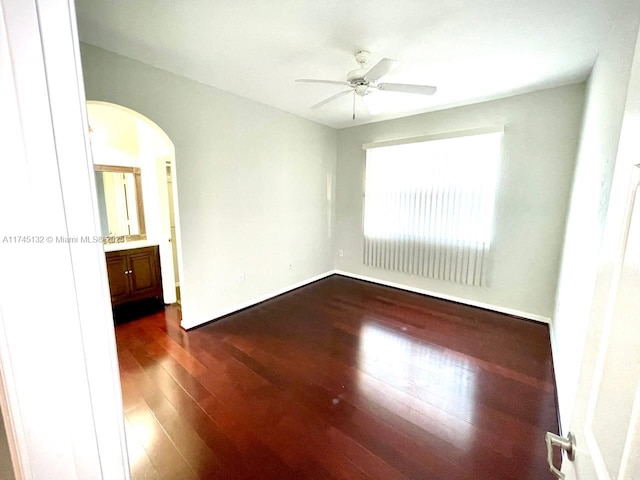 unfurnished bedroom featuring dark hardwood / wood-style flooring and ceiling fan