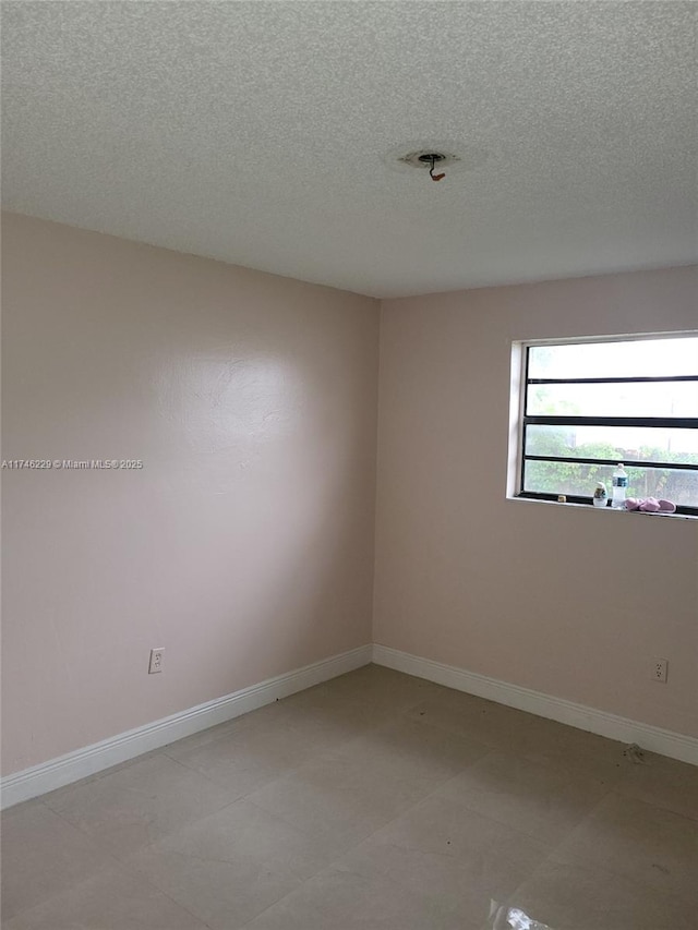 spare room with a textured ceiling