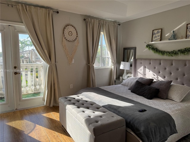 bedroom with light hardwood / wood-style floors and access to outside