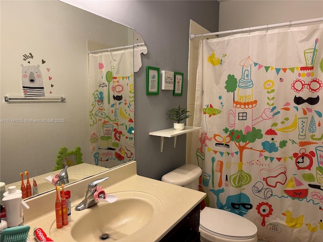 bathroom featuring walk in shower, vanity, and toilet