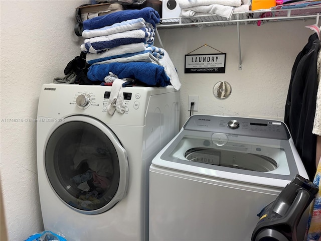 laundry area with washing machine and clothes dryer