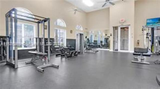 workout area featuring a towering ceiling