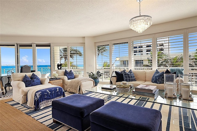 living area featuring a chandelier and a textured ceiling