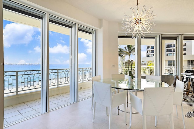 unfurnished dining area featuring a water view and a notable chandelier