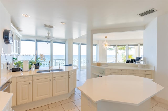 kitchen with light countertops, visible vents, a sink, and light tile patterned flooring