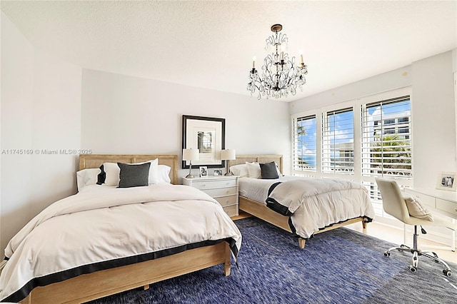 bedroom featuring a chandelier and a textured ceiling