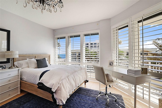 bedroom with a textured ceiling and wood finished floors