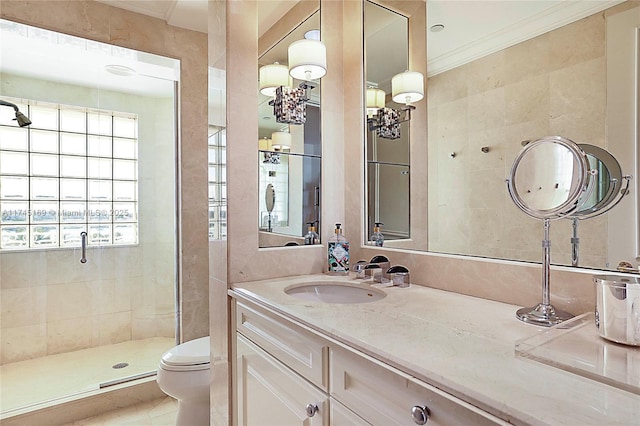 full bathroom with a stall shower, vanity, toilet, and crown molding