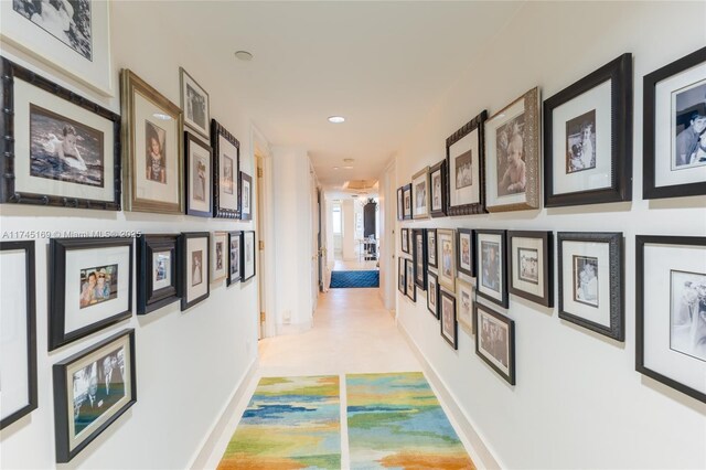 hallway with baseboards and recessed lighting