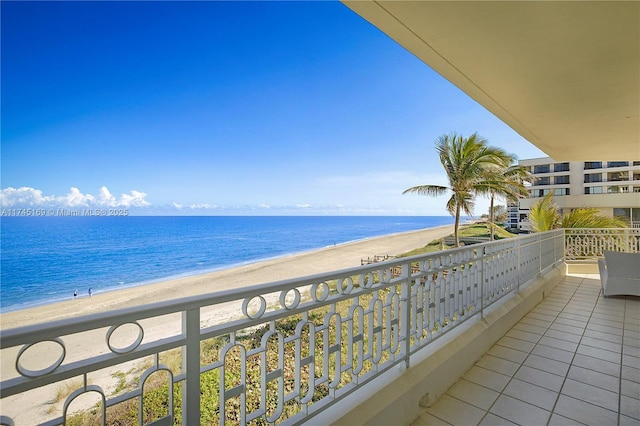 balcony with a beach view and a water view