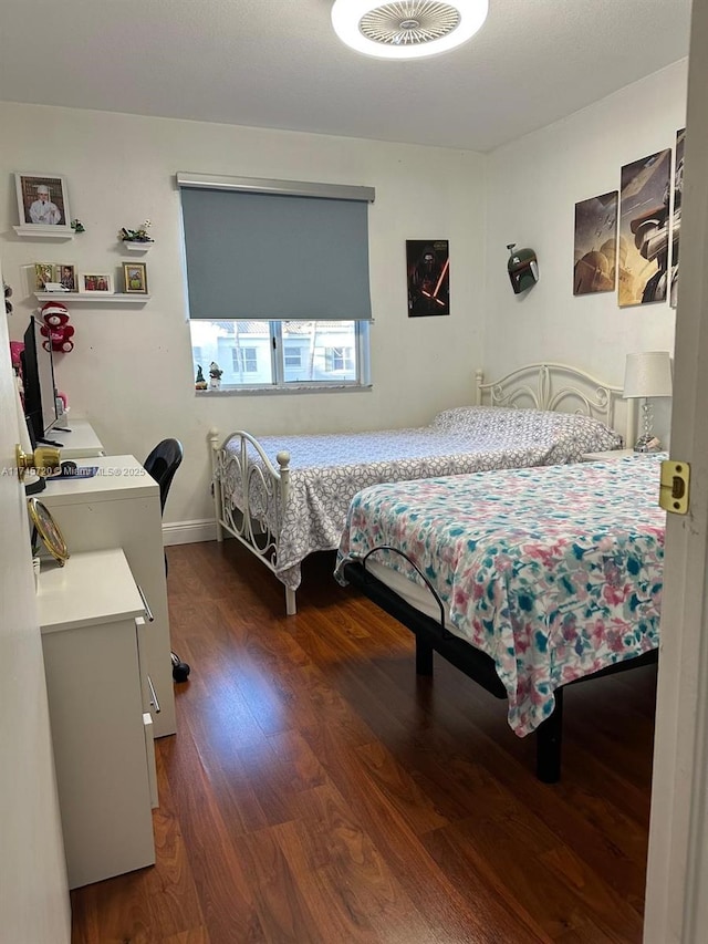 bedroom with dark wood-type flooring