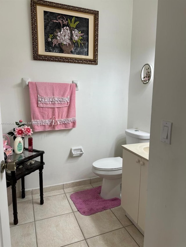 bathroom with vanity, tile patterned floors, and toilet