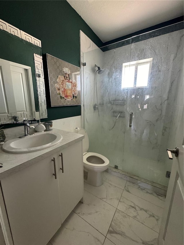 bathroom with a marble finish shower, toilet, marble finish floor, a textured ceiling, and vanity