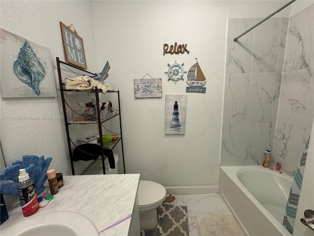 bathroom featuring toilet, vanity, bathing tub / shower combination, baseboards, and marble finish floor