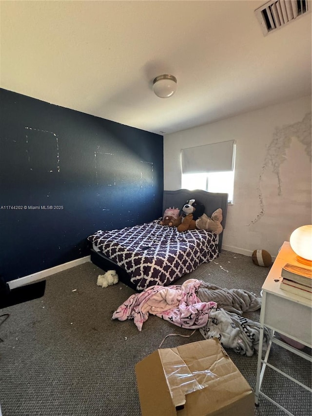 unfurnished bedroom featuring baseboards, visible vents, and carpet flooring