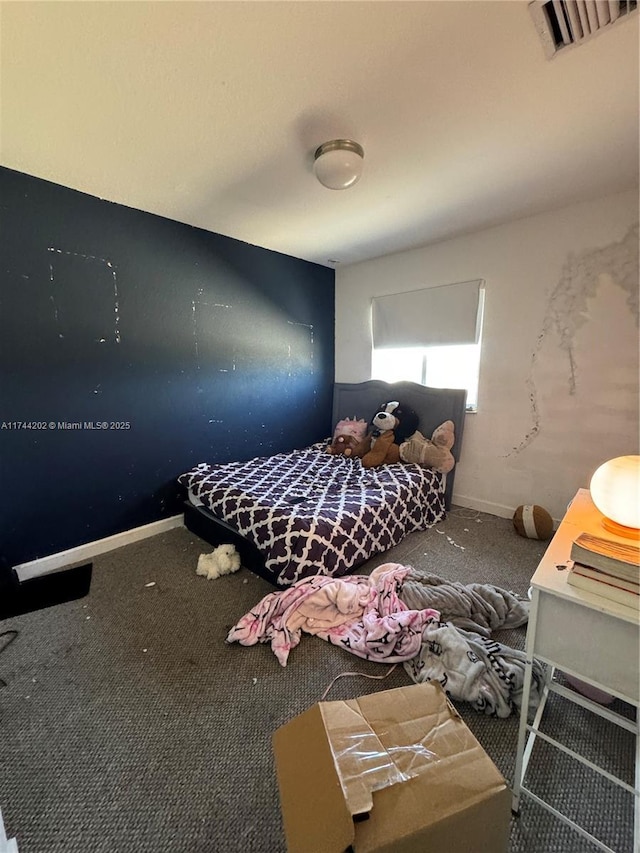 unfurnished bedroom featuring carpet, visible vents, and baseboards