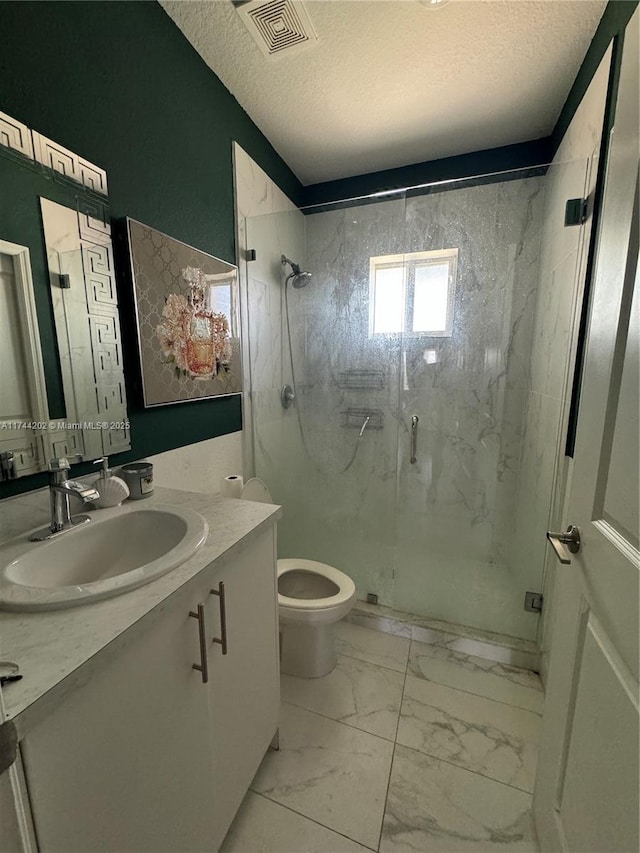 bathroom with marble finish floor, visible vents, a textured ceiling, and vanity